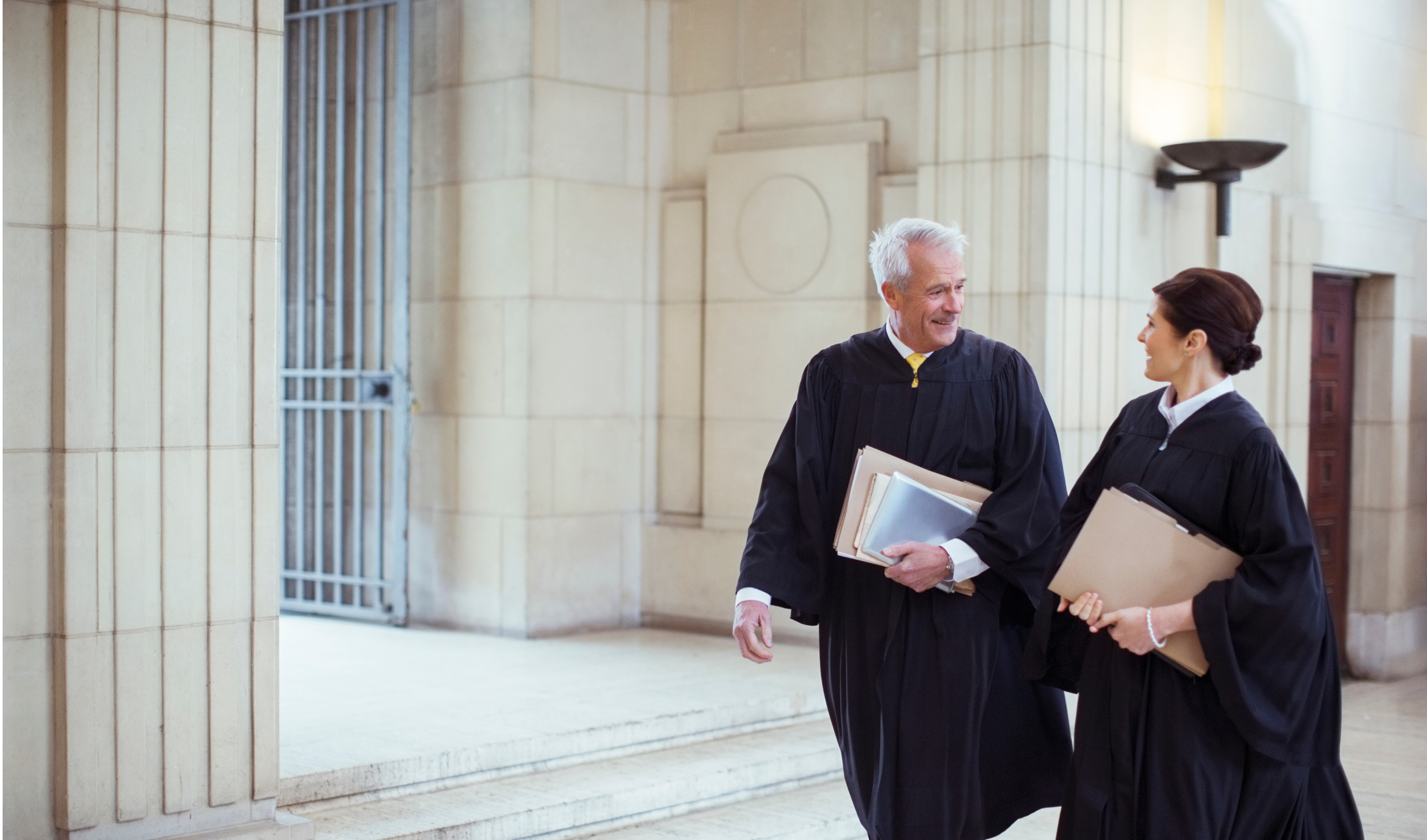 Two lawyers walking and smiling together