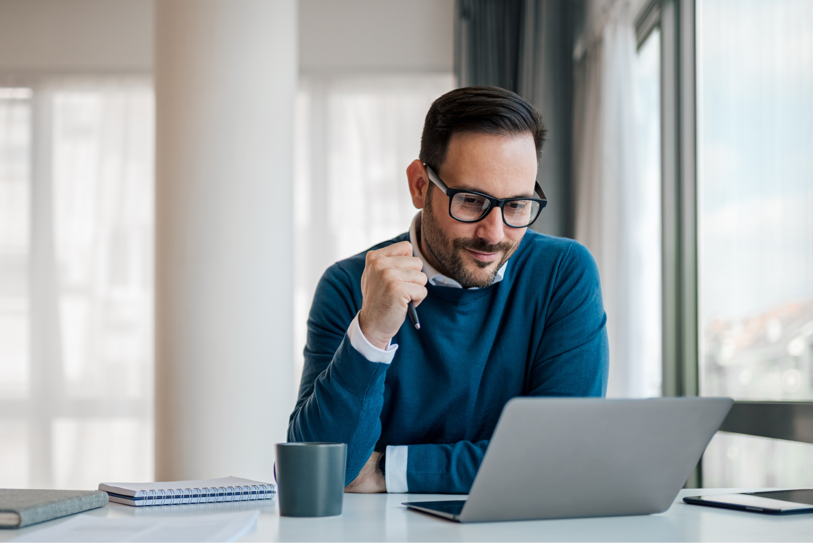 Man sitting using a laptop at his desk