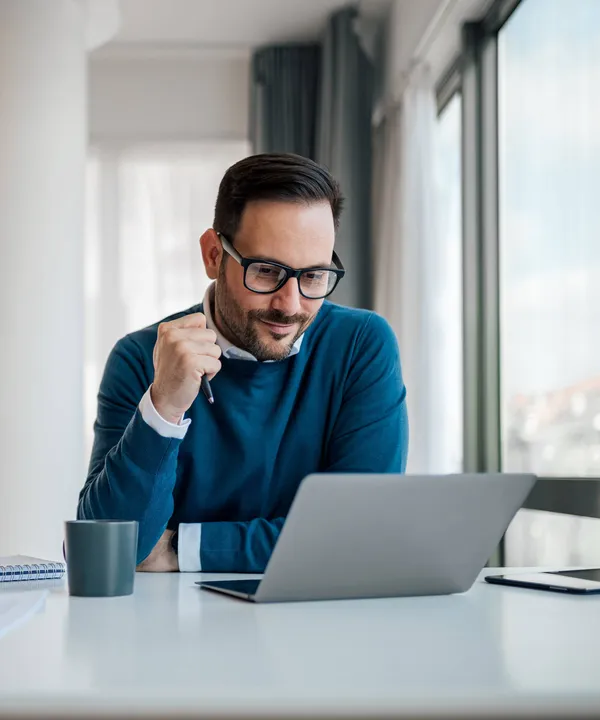 A man using a laptop at his desk